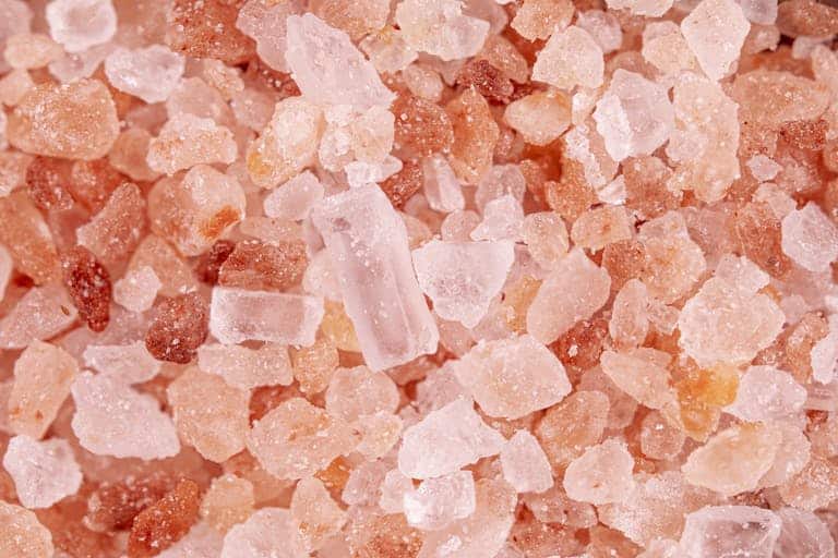 Macro image showcasing the detailed texture and color of pink Himalayan salt crystals.